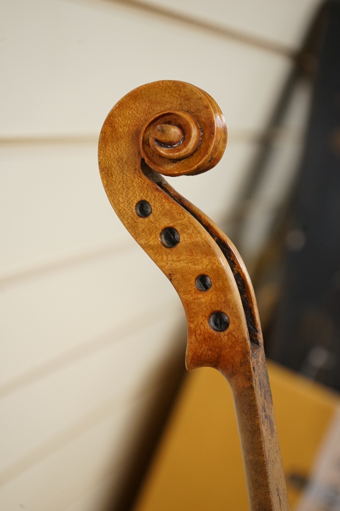 Three violins; a late 19th century German Stradivarius pattern violin, without label, a handmade violin (a.f.), with sound post crack, broken and repaired scroll, etc. and a Maidstone violin body, varnish stripped from t